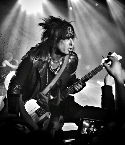 Nikki Sixx on tour with Six AM. I was about 15 feet back and did cropped in post. The colors were awful as most concert photography is, so I just converted to black and white.
